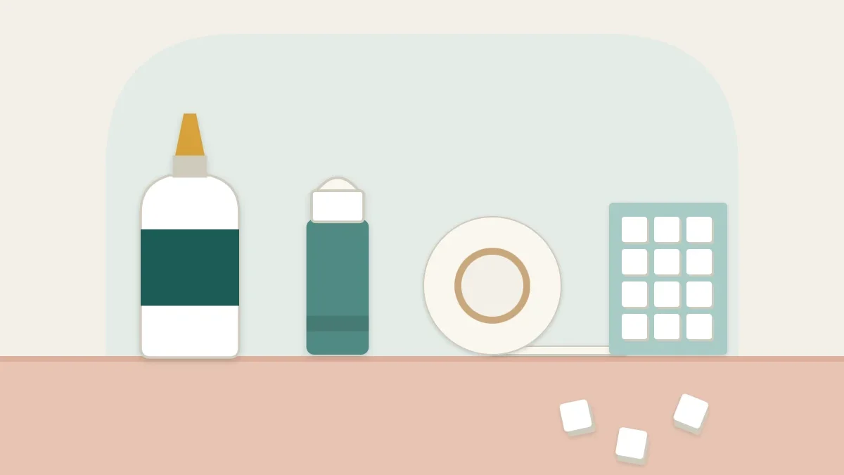 A bottle of PVA glue, a glue stick, a roll of double-sided tape and foam squares lined up