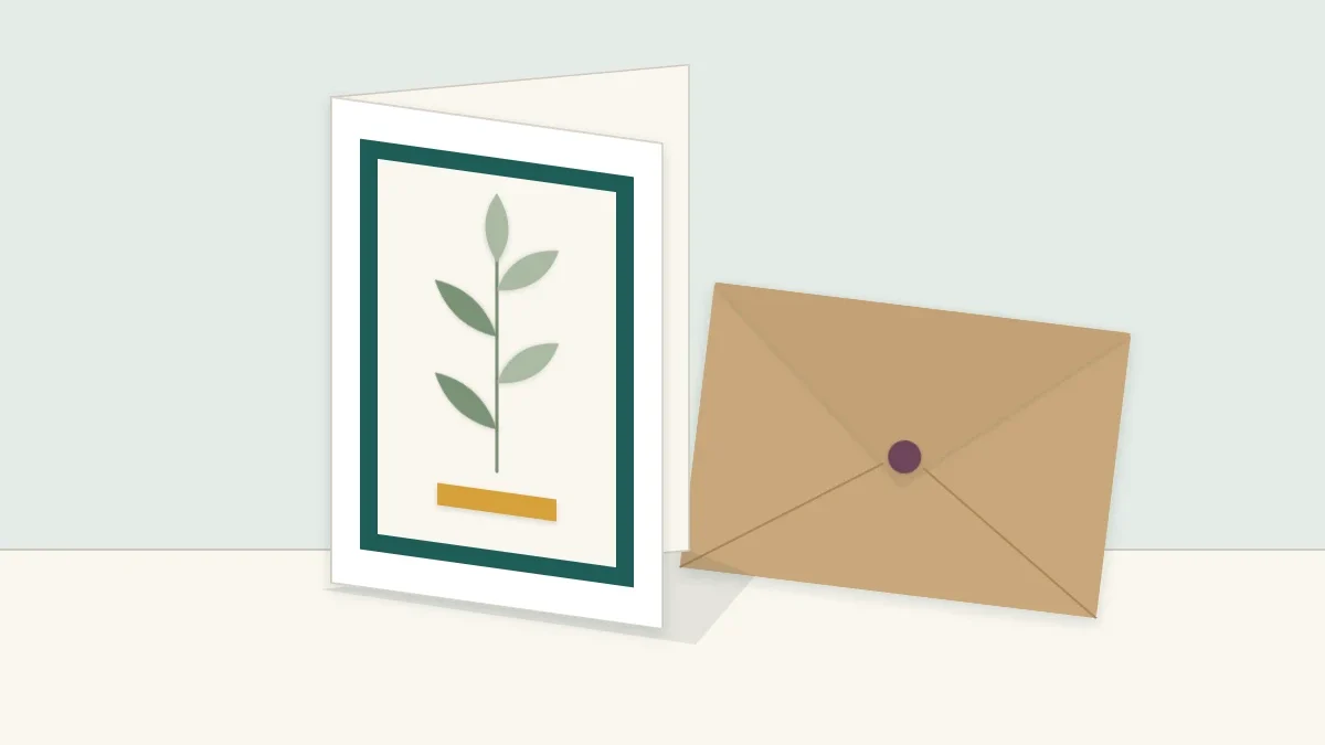 Handmade layered greeting card standing upright beside its matching envelope