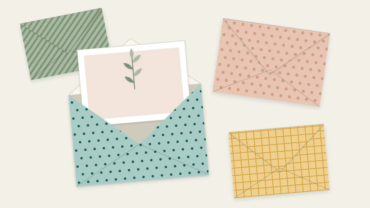 Handmade envelopes in patterned paper with a card partly tucked into one