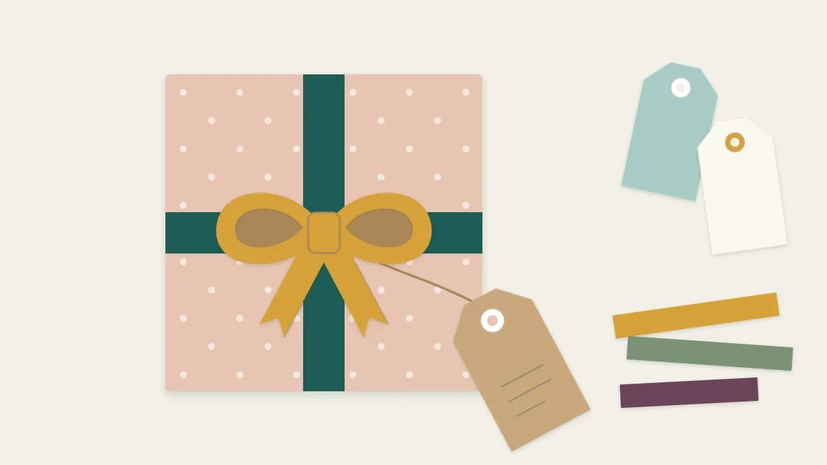 A wrapped gift finished with a paper bow and a handmade paper tag