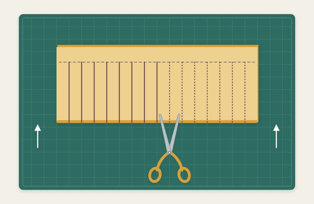 Sheet of cardstock folded in half with evenly spaced parallel cuts running from the fold and stopping short of the open edge