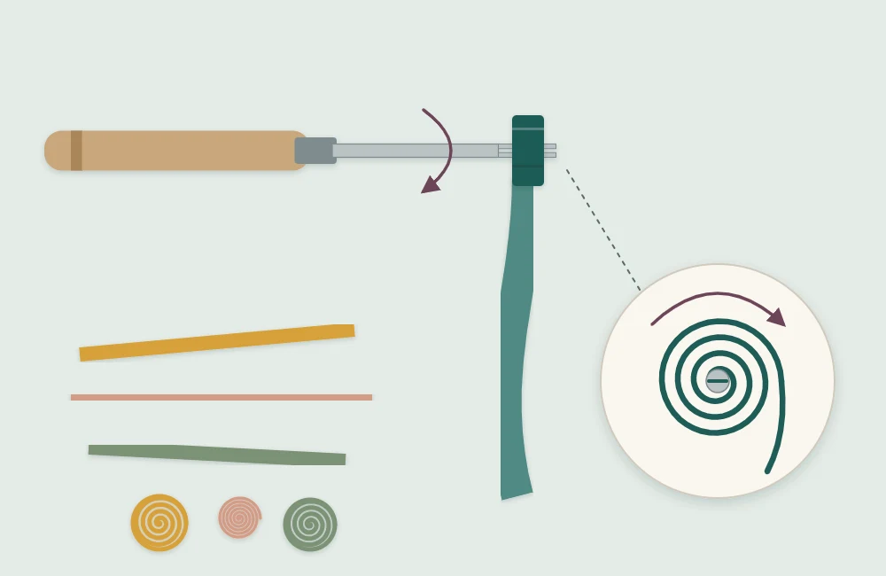 Narrow paper strip being wound into a coil on the split tip of a slotted quilling tool