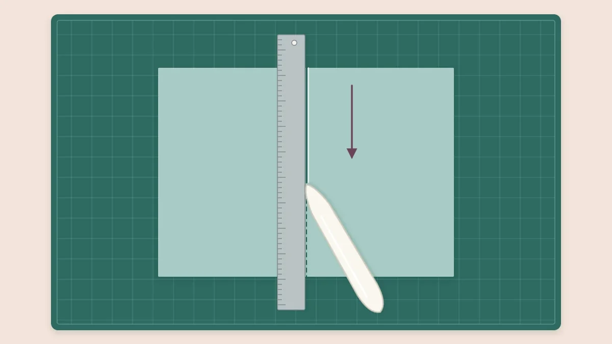 A bone folder scoring a line along a ruler on a sheet of cardstock