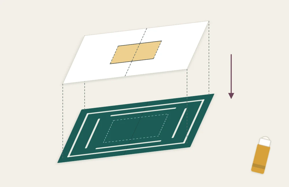 A slightly larger cover card being glued behind the pop-up liner, hiding the cut openings